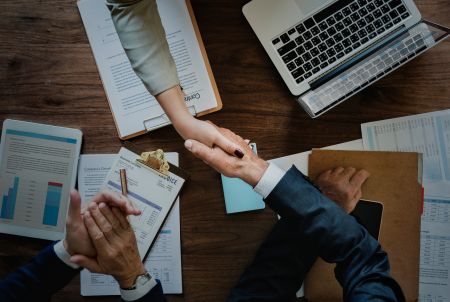 business-people-shaking-hands-together (1)